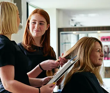 students working on a hair client